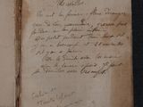 an old book with writing on it sitting on a table