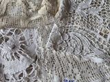 a close up of a table cloth with lace on it