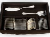 many forks and spoons in a box on the table