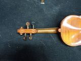 a violin that is laying on a black surface