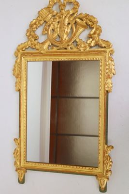 a mirror that is sitting on the wall next to a shelf