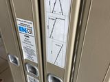 two metal lockers that have signs on them on them
