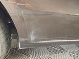 a close up of a car door with a tire on it