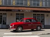 a red car parked in front of a hotel