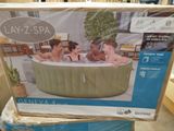 an inflatable hot tub sitting on top of a table in a store