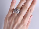 a woman ' s hand holding a stack of three rings