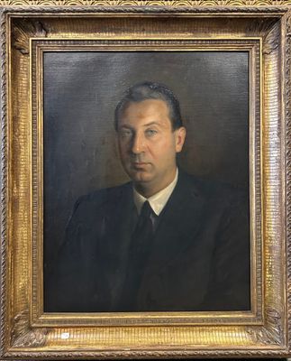 portrait d'un homme en costume-cravate dans un cadre doré