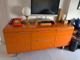 an orange cabinet with a telephone on top of it