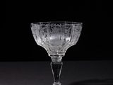 an empty wine glass sitting on top of a black table