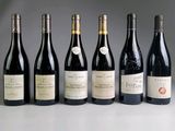 several bottles of wine are lined up on a table