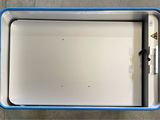 a blue and white cooler sitting on the floor