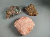 three different colored rocks sitting on a plate