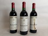 three bottles of wine sitting on top of a table next to each other