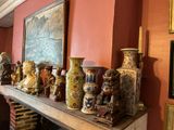 de nombreux vases posés sur la cheminée d'une pièce
