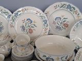 many plates and bowls that are sitting on a table