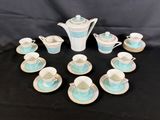 many cups and saucers arranged in a circle on a table