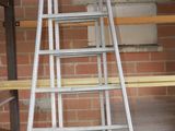 many ladders that are stacked up in a room