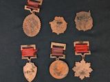 five medals and a medal on a black surface