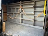 the back of a van with shelves in the back of it