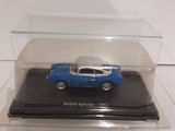 a small blue car in a clear case