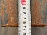 measuring the length of a piece of rusted metal with a ruler