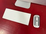 a computer monitor and a mouse on a red table