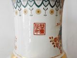 a vase with a design on it sitting on a table