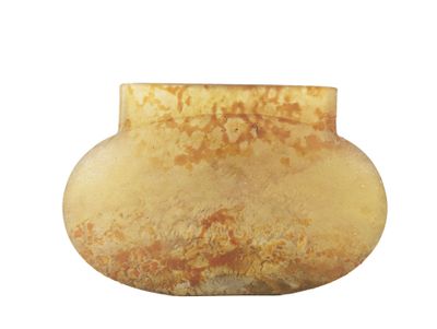 a yellow vase that is sitting on a white surface