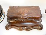 a small wooden box sitting on a table next to a lamp