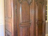 an image of a large wooden armoire in a living room