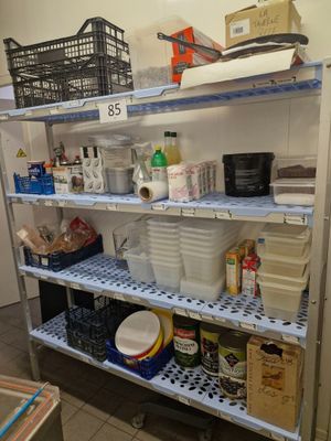 a metal shelving with many items on it