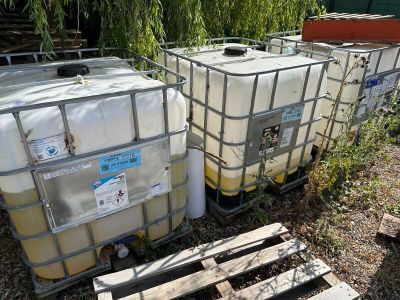 two large containers sitting next to each other on the ground