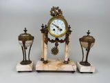 a clock that is sitting on top of a marble stand