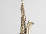 a close up of a silver saxophone on a white background