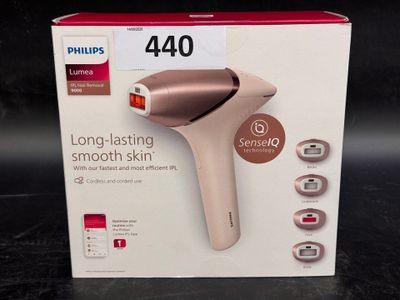 packaging of a pink hair dryer sitting on top of a black table
