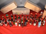 a lot of bottles of alcohol on a red table