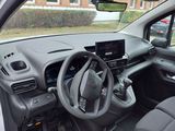 the interior of a small car with a steering wheel and dashboard