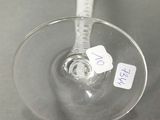 a wine glass with a tag on it sitting on a table