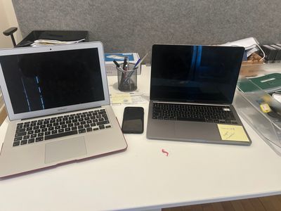 two laptops that are sitting on a table