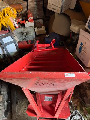 a red dumpster sitting in the middle of a pile of boxes