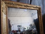 a mirror that is sitting on a table in front of a wall