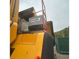 the back end of a construction vehicle with a sign on it ' s side