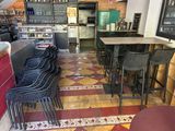 tables and chairs in a restaurant with a tiled floor