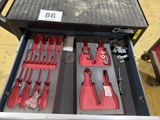 many tools in a tool box on the floor