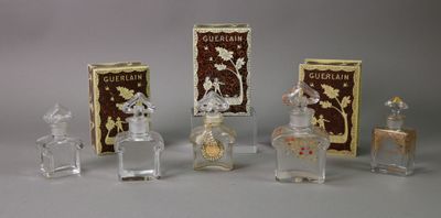 five small bottles of perfume sitting on a table
