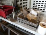 a table with a bunch of boxes and a roll of toilet paper on it