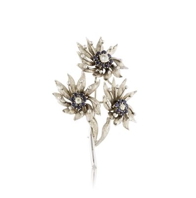an image of a silver flower broochle on a white background