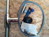 a picture of a hose and a wrench on a wooden floor