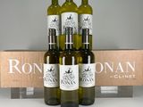 three bottles of wine are sitting in front of a box of wine