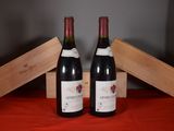two bottles of wine sitting next to each other on a table